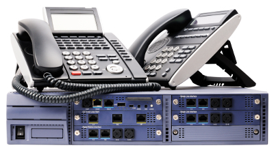 A photo of two VoIP phones sitting on top ofa telephony switch